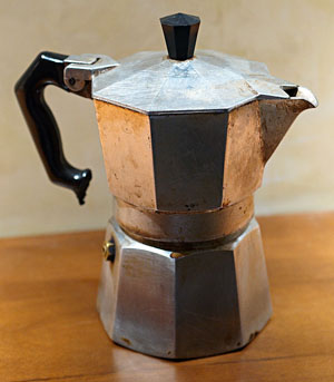 The Italian Alfonso Bialetti, 1888 - 1970, invented in 1933 the Mocha Express. The Mocha Express looks like an octagonal aluminum jug with lid. The lower part is filled up to the valve-level with water. The middle part, which gets filled with ground coffee, fits therein. The upper part, which receives the coffee, is screwed onto the lower part. The jug has a handle and the lid a button, both made of black plastic.  Source: Imm808 2007 commons.wikimedia